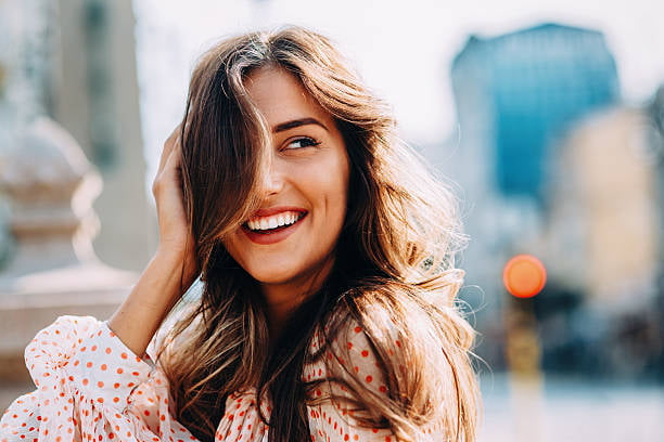 A woman laughing in the sunshine